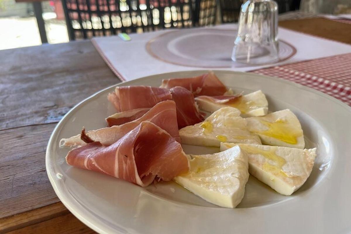 krožnik hrane z mesom in sirom na mizi