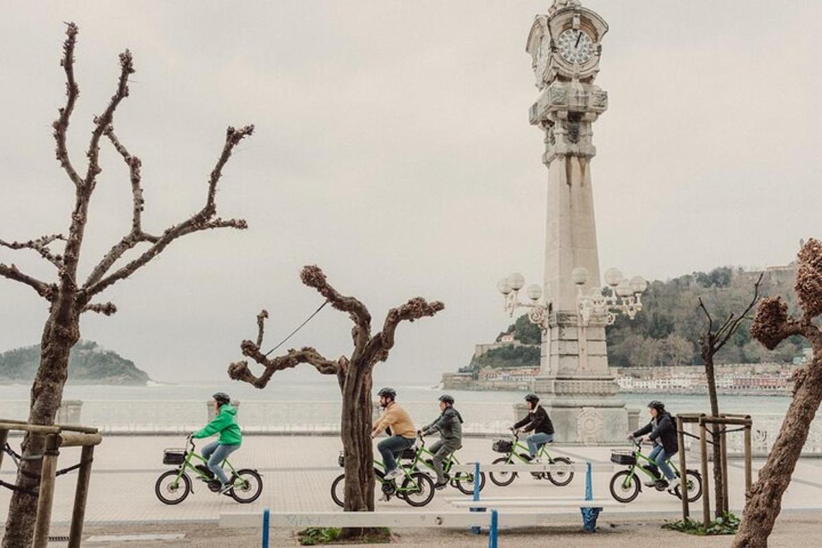 a group of people riding bikes in front of a clock tower
