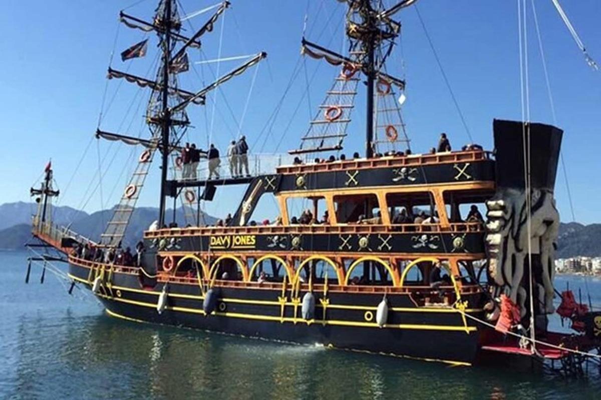 a pirate ship in the water with people on it