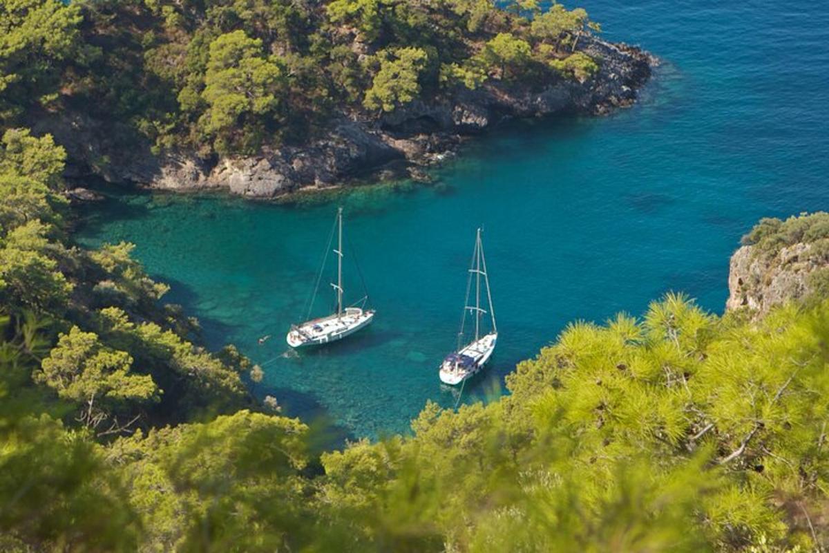 two boats are docked in a cove in the water