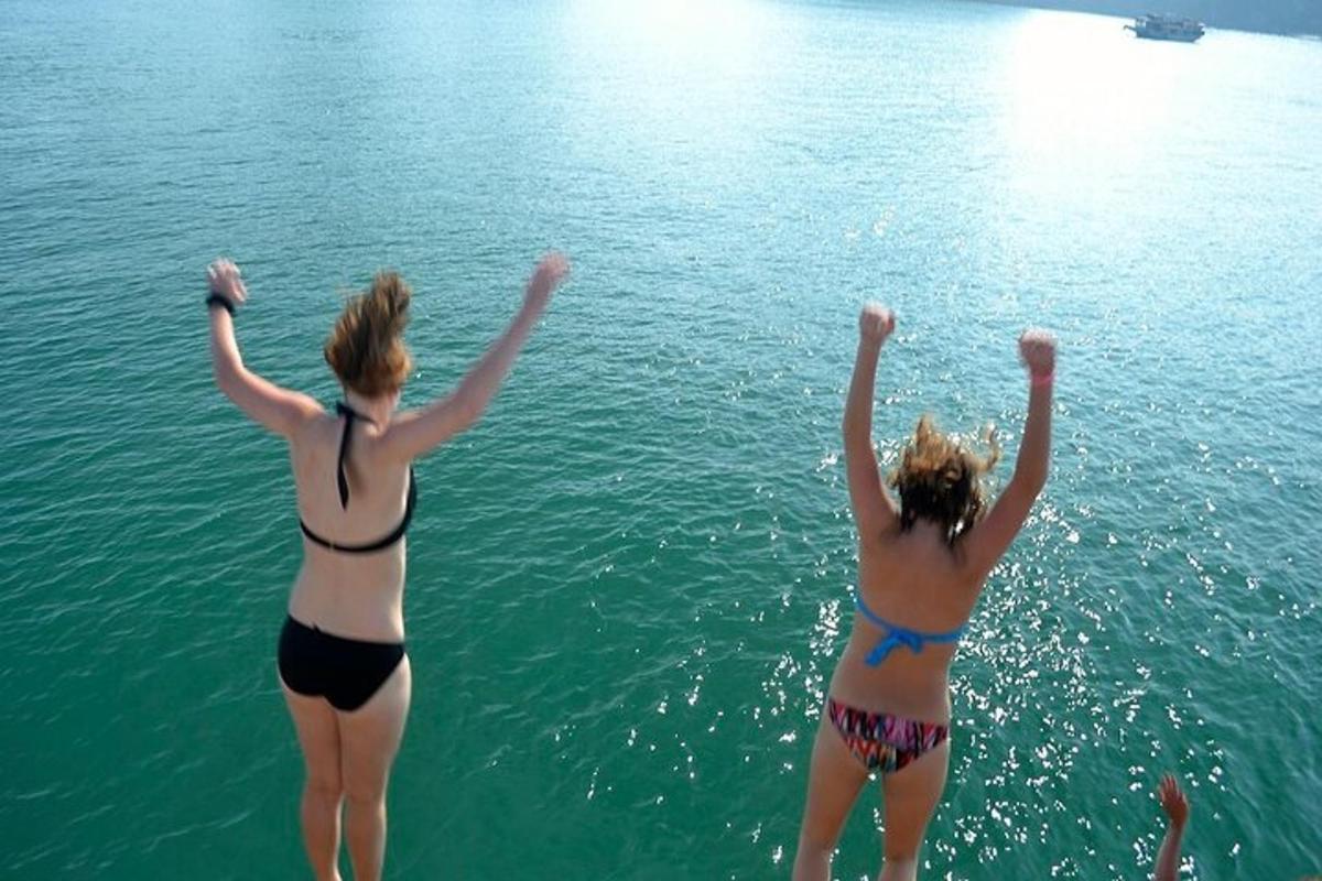 two women in bathing suits standing in the water