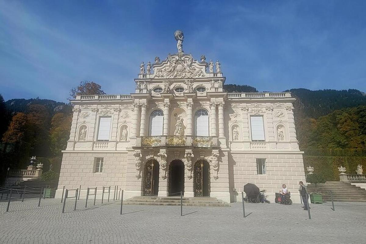 a large stone building with people sitting in front of it