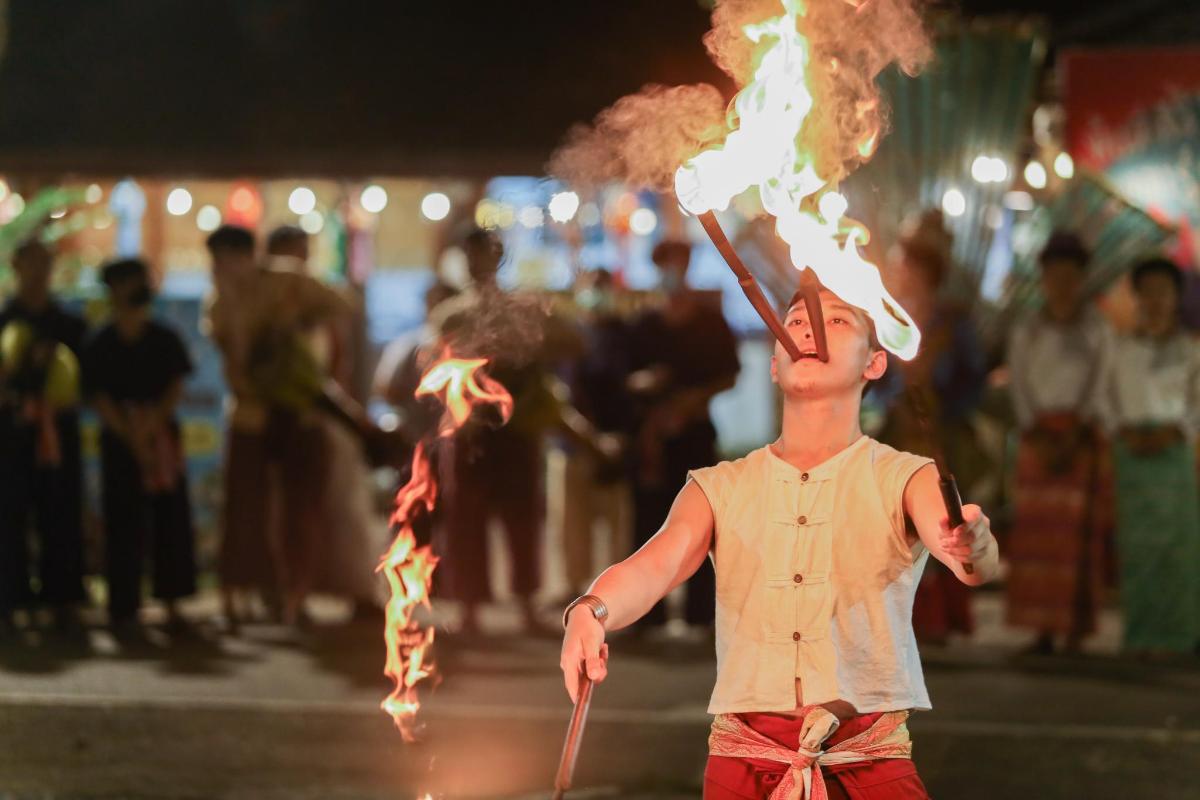 a young boy with a fire on his head
