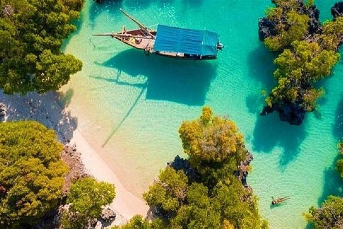 a boat in the water next to a beach