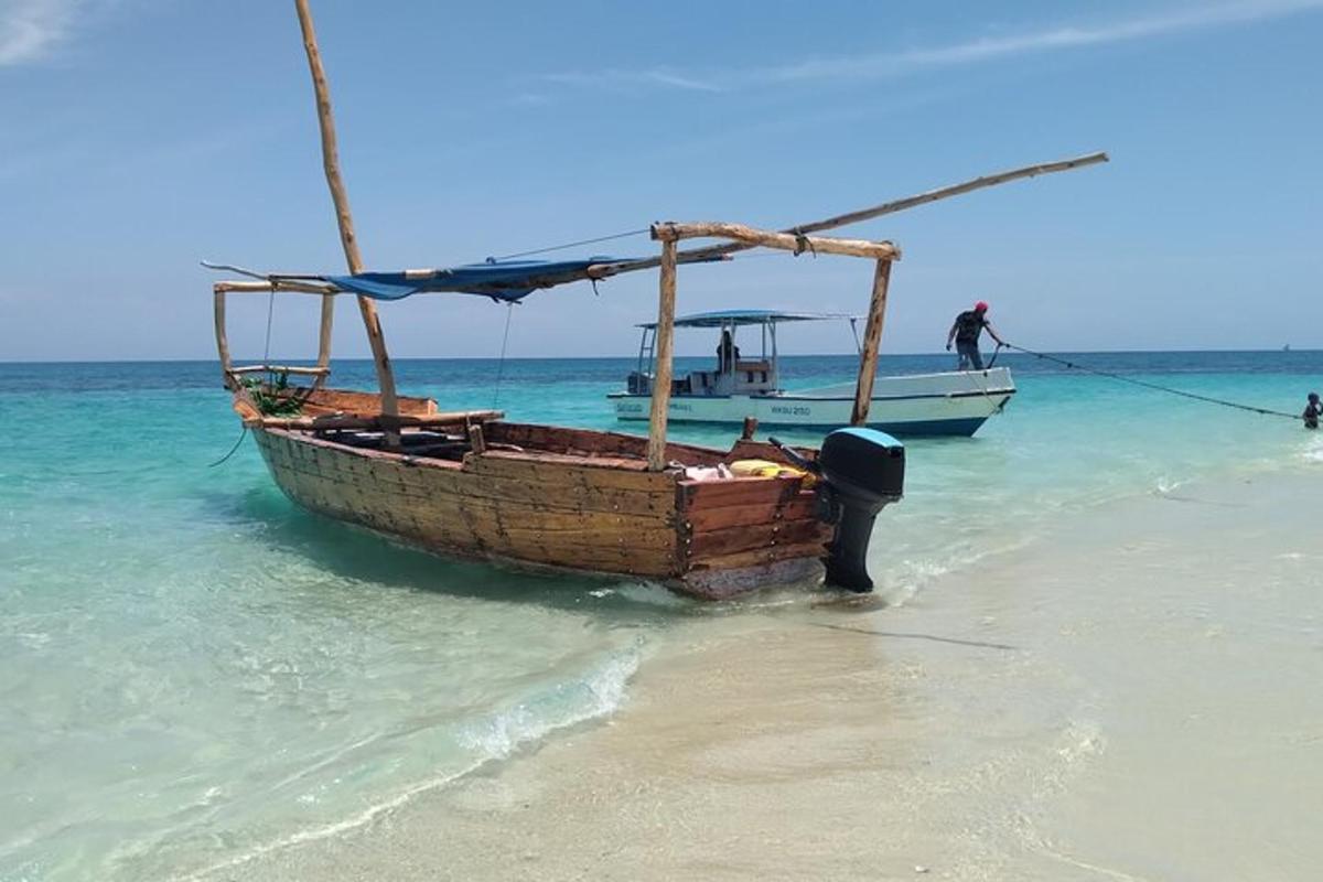 a boat sitting in the water on a beach