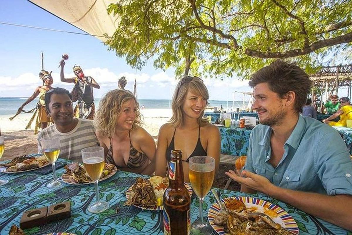a group of people sitting at a table at the beach
