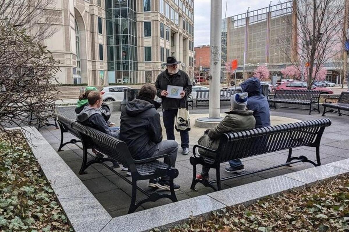 a group of people sitting on benches in a city
