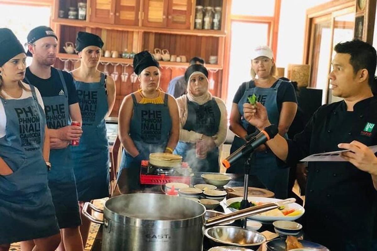 a group of people standing in a kitchen preparing food