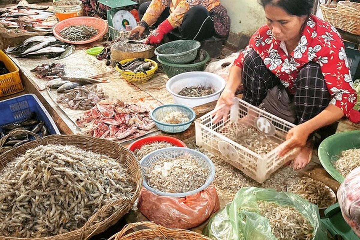 a woman sitting on a table with baskets of food