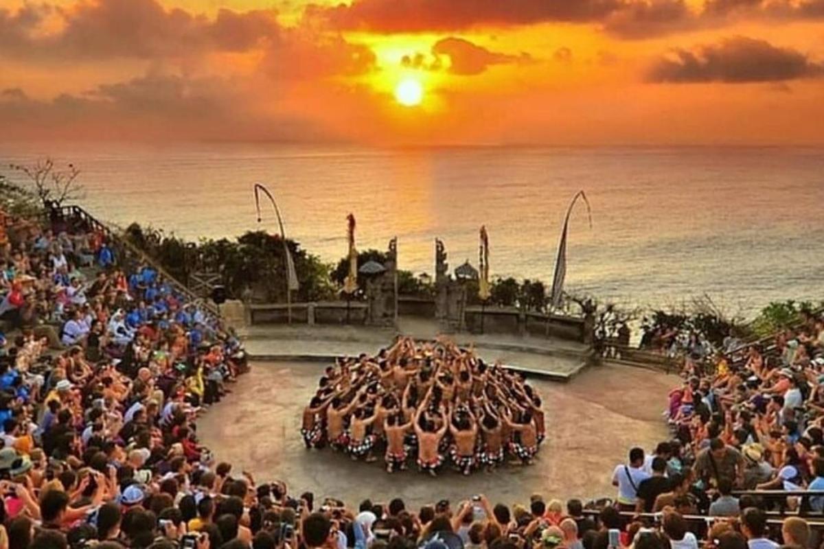 a large crowd of people watching a stage with a group of animals