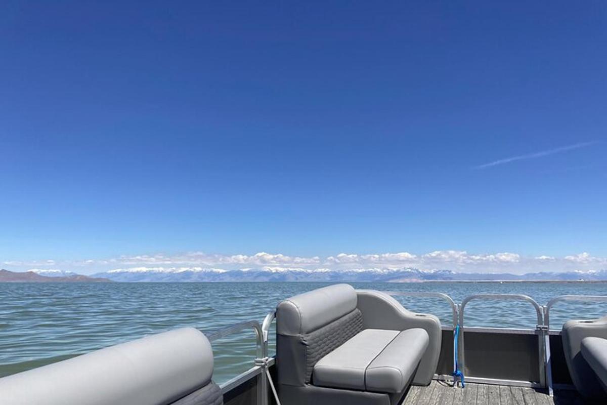 a boat with two chairs on the water