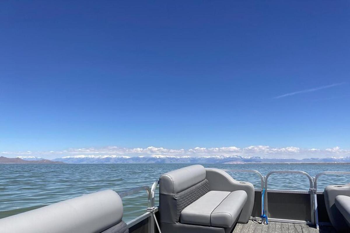 a boat with two chairs on the water