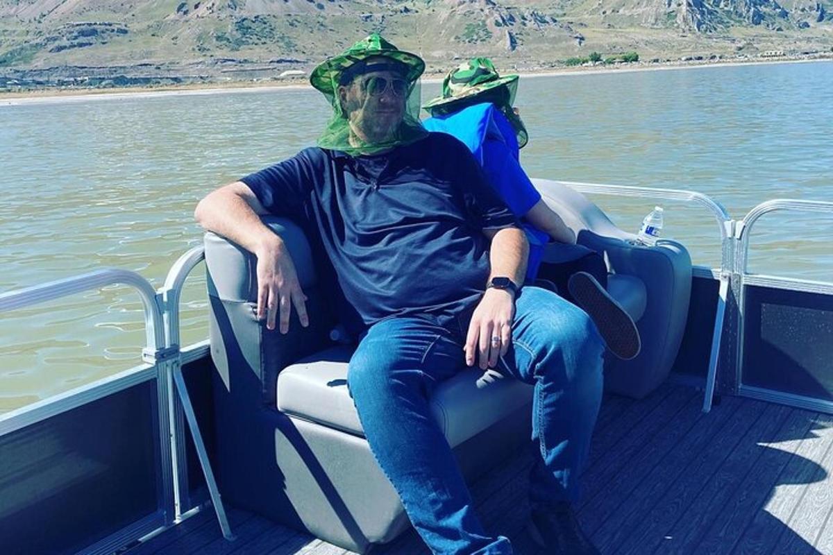 a man sitting in the back of a boat