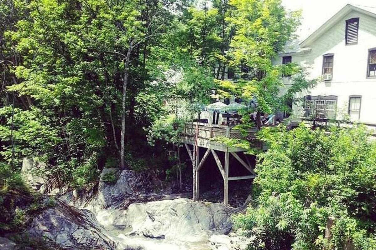 a house with a deck on top of a river