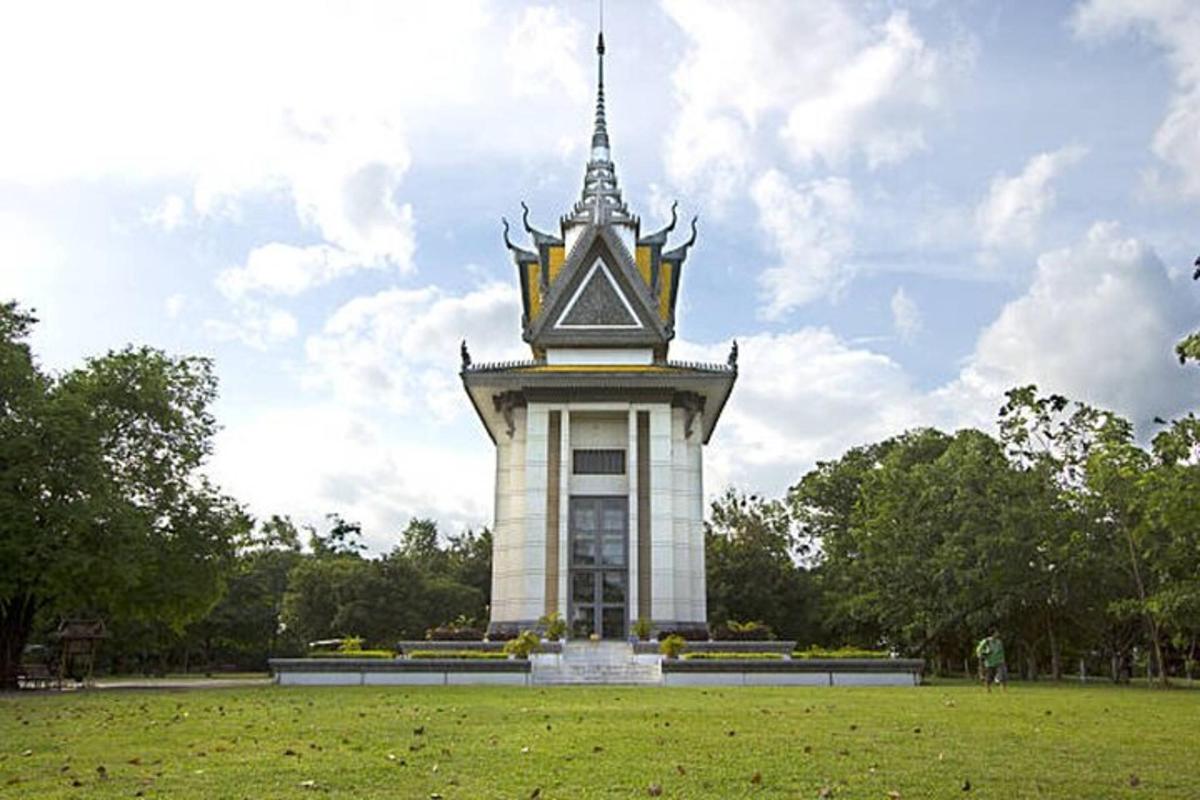 Una gran torre en un parque con un campo de césped.