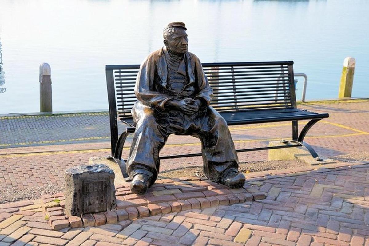 a statue of a man sitting on a bench