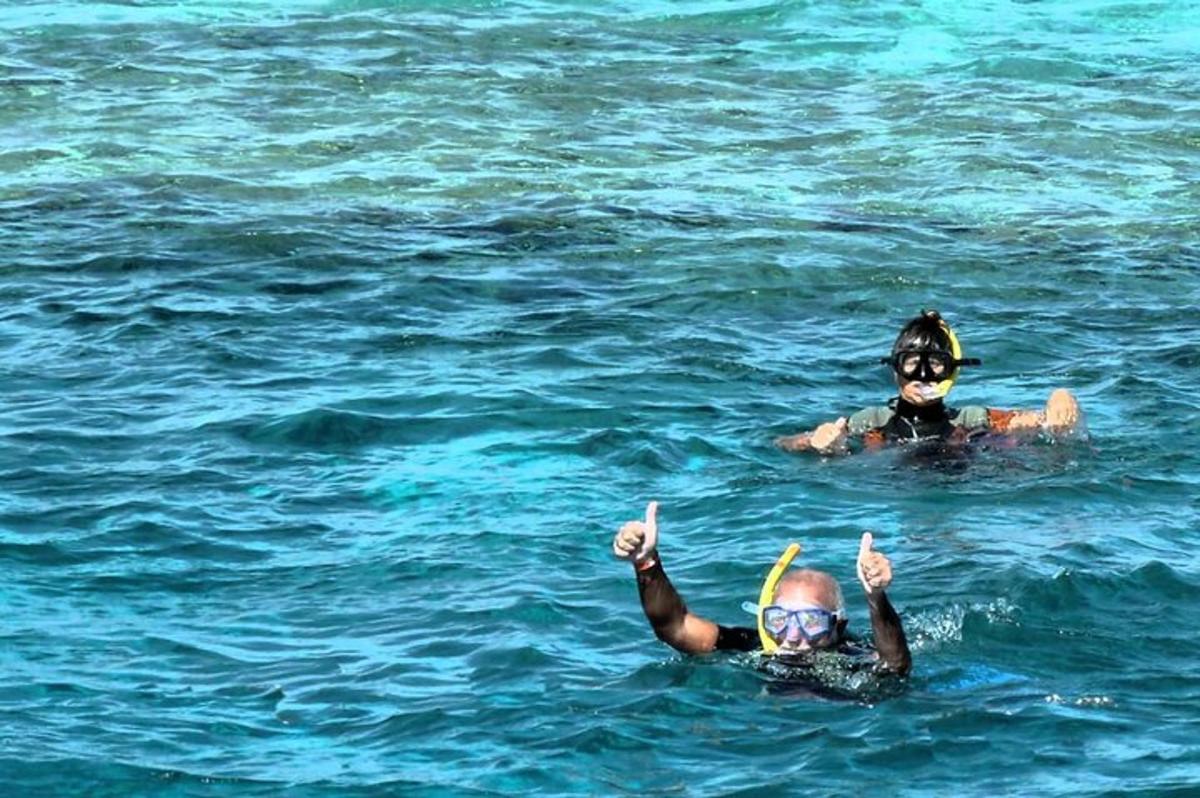 two people in the water giving thumbs up