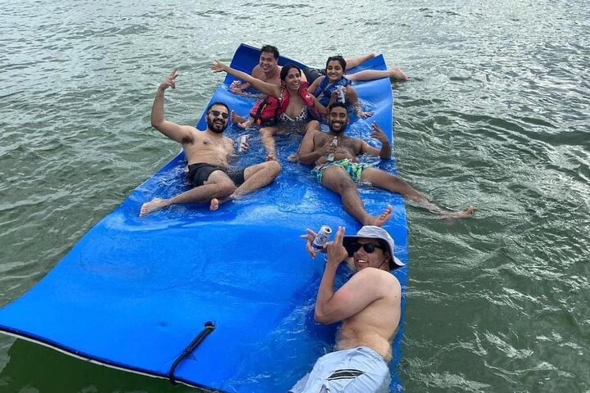 Un grupo de personas sentadas en una balsa azul en el agua.