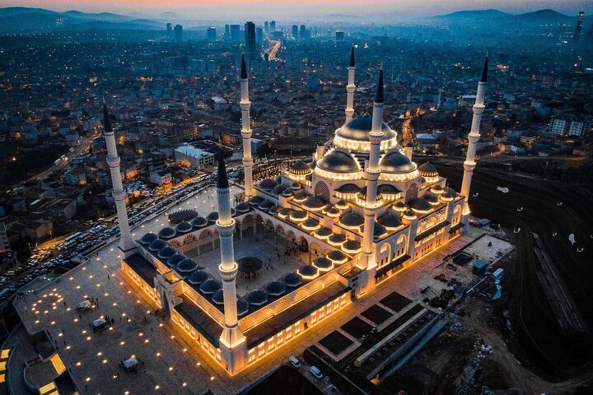an overhead view of a large mosque with lights