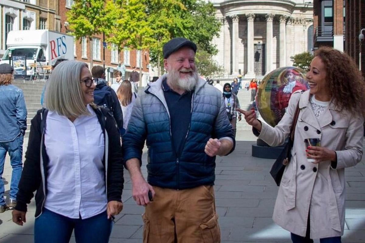 a man and two women walking down a street