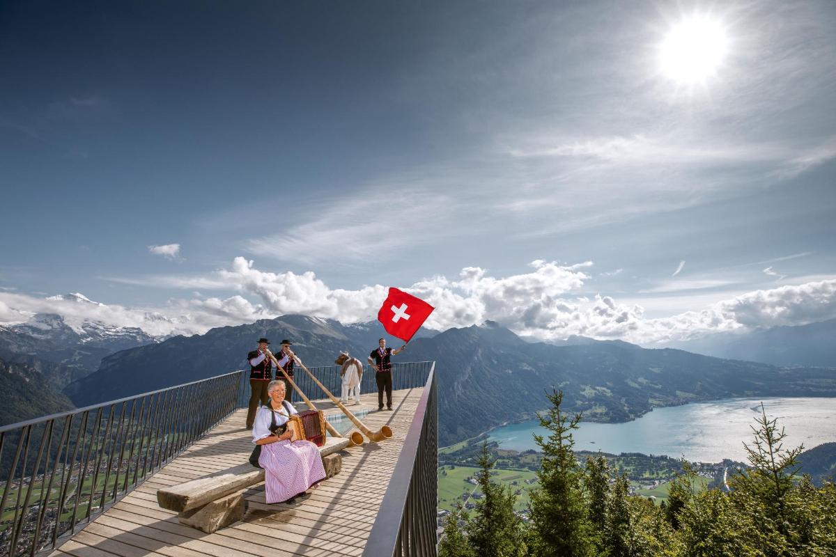 a group of people on a viewing deck with a canadian flag