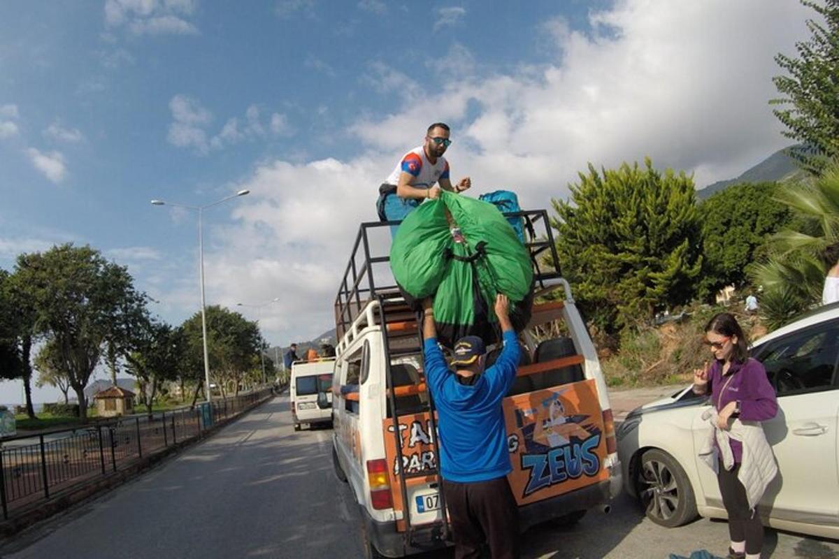 a man is standing on top of a bus