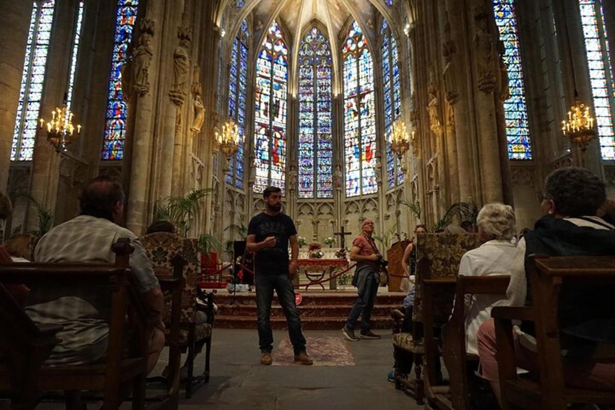 a man standing in a church with a stained glass window