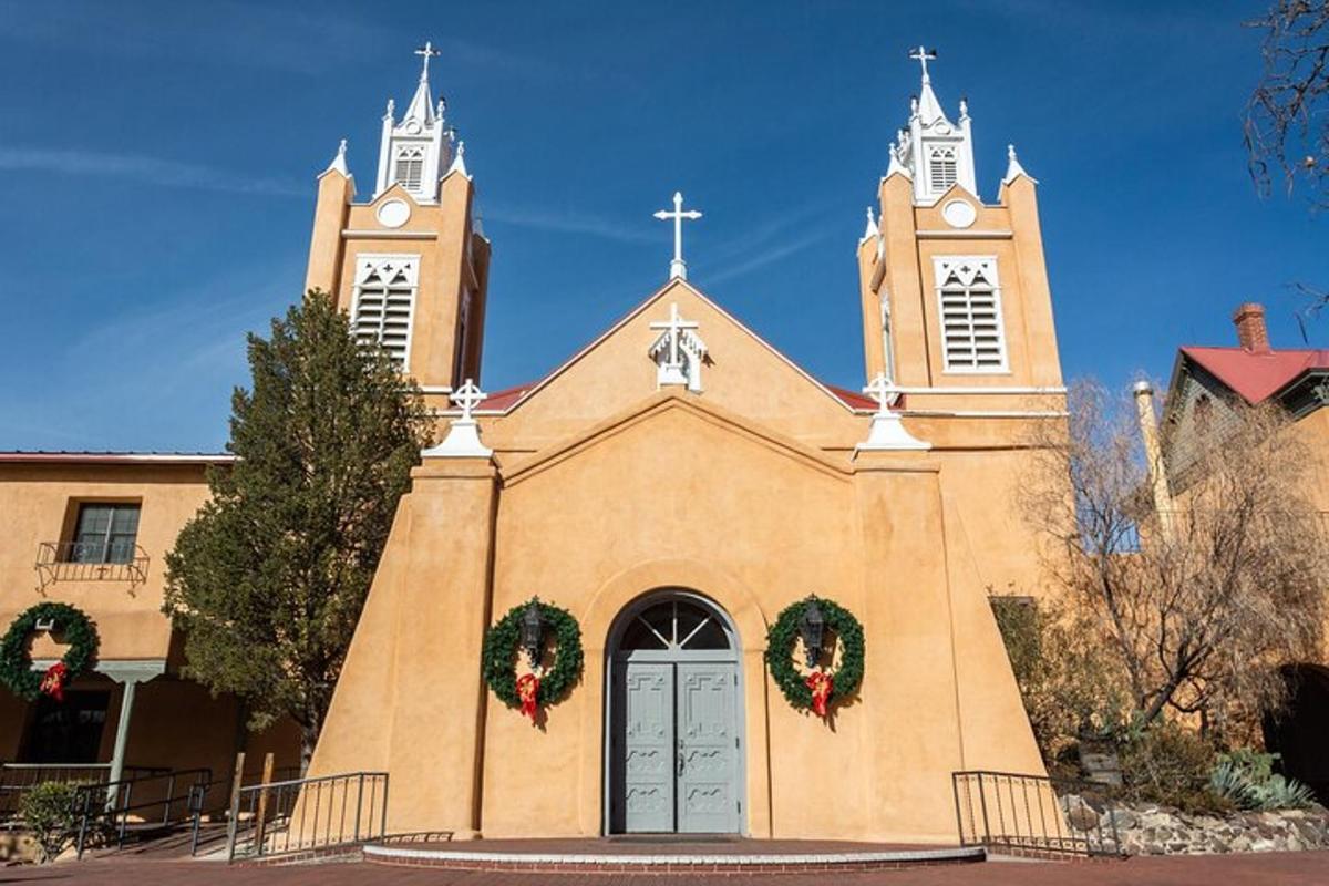 a church with two towers with christmas wreaths on it