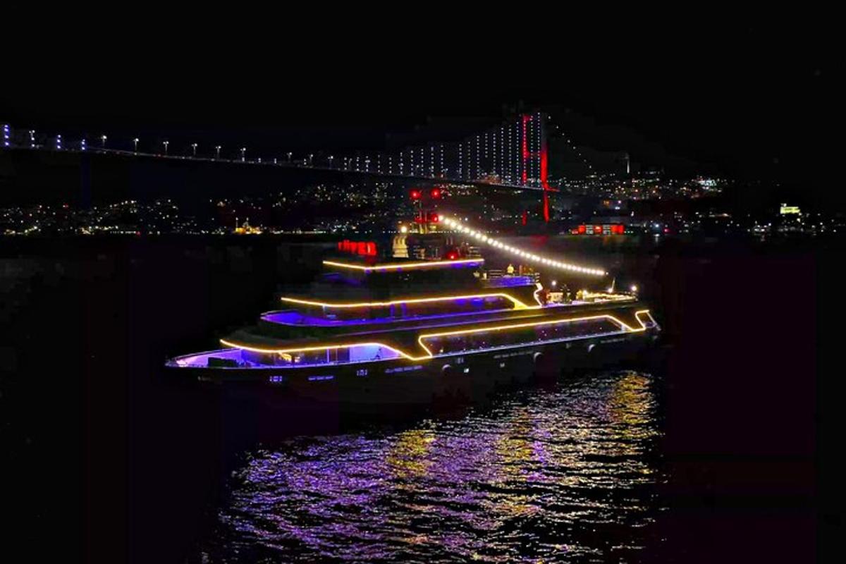 a group of boats in the water at night