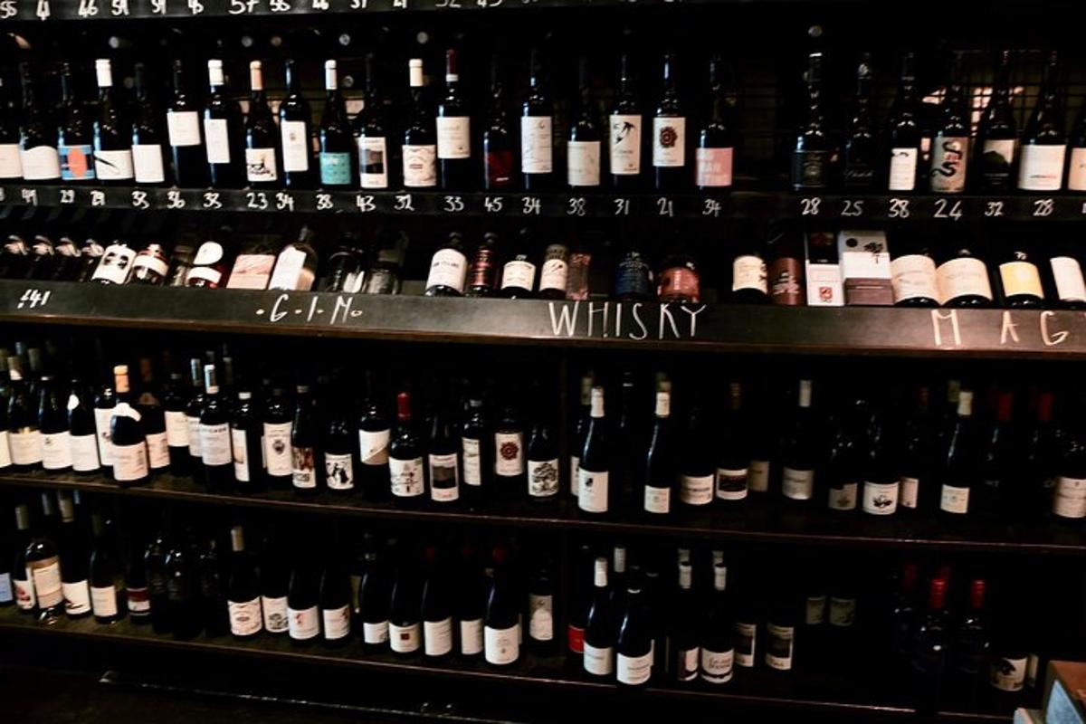 a bunch of bottles of wine on a shelf