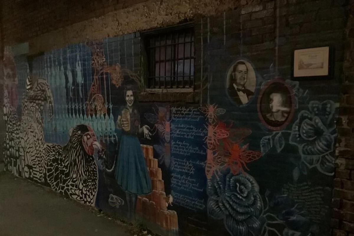 a mural on the side of a brick wall
