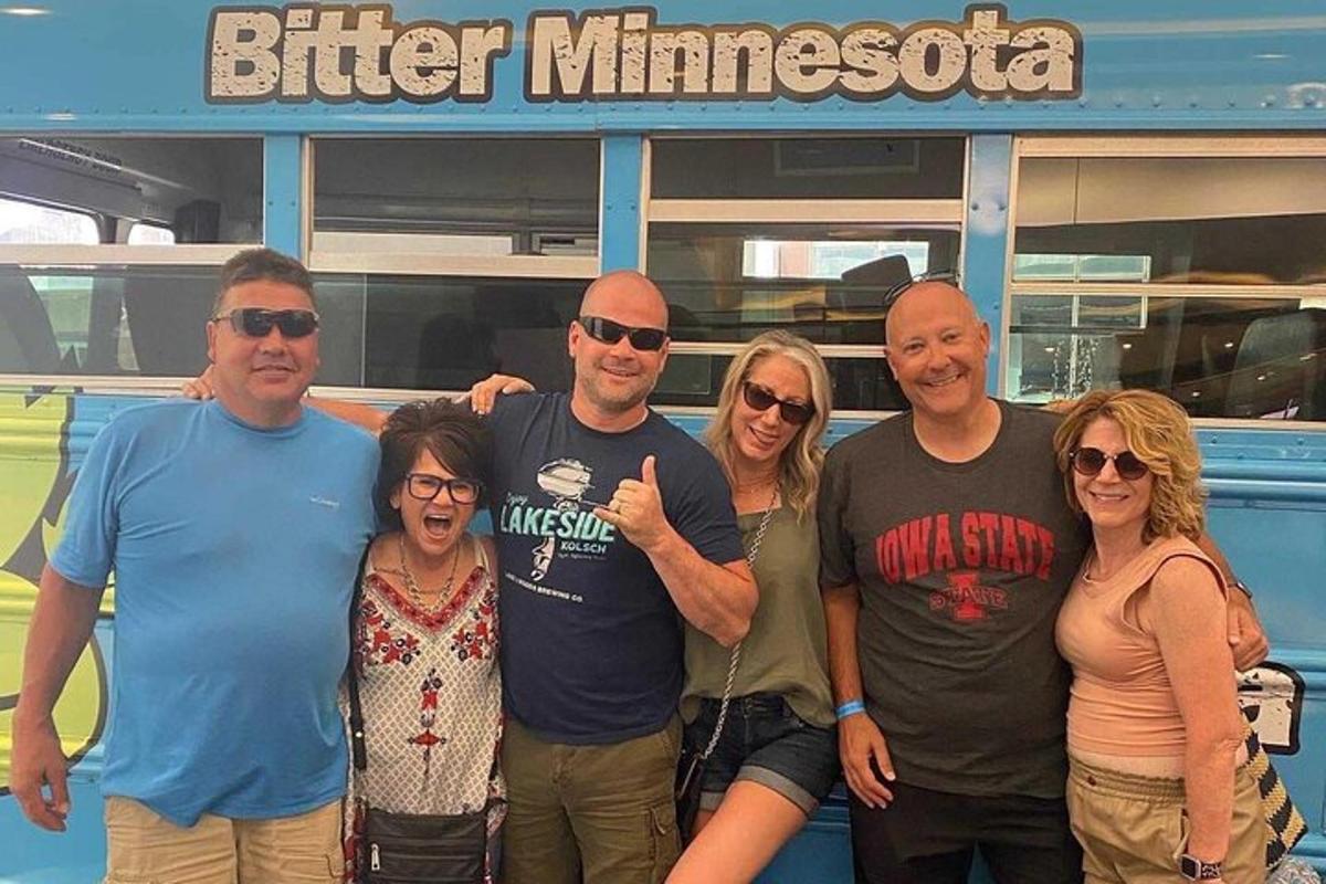a group of people standing in front of a bus