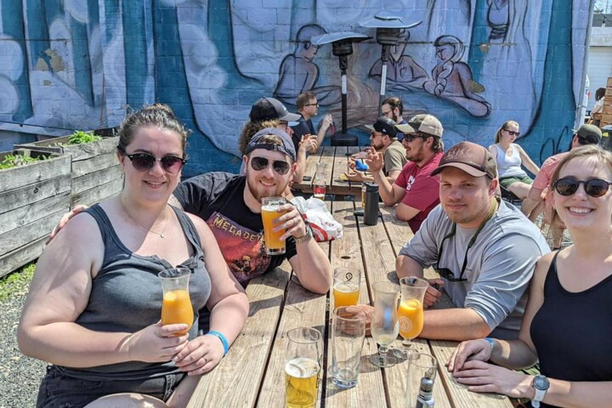 a group of people sitting at a table drinking beer