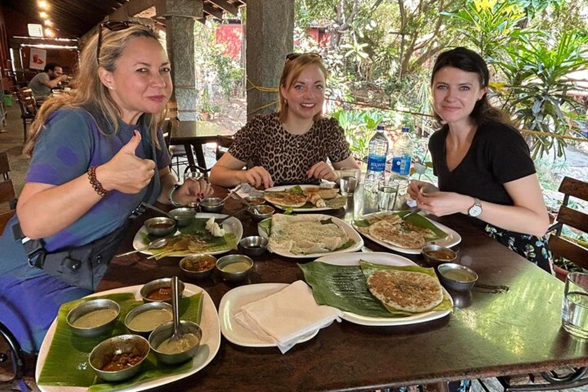 three women sitting at a table eating food