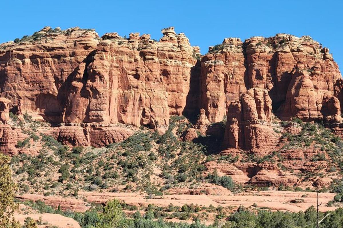 a mountain with tall red rocks in the desert