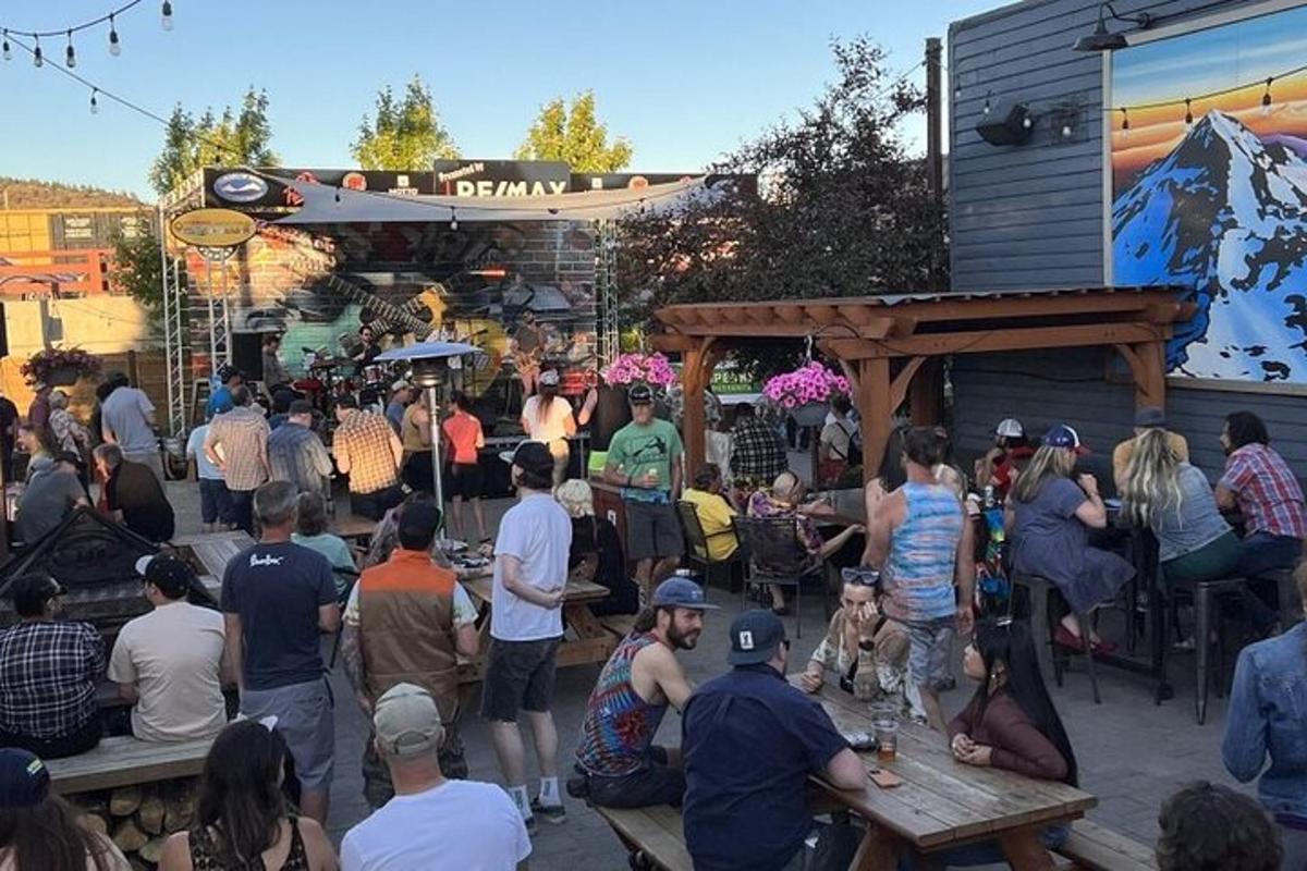 a crowd of people sitting outside of a building