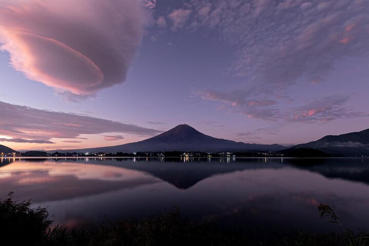 uma vista de uma montanha e um lago ao pôr do sol