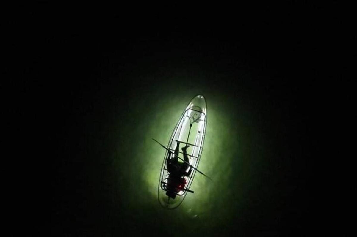 a glass object in the dark with a green light