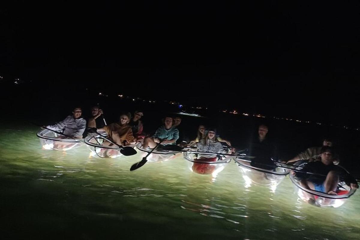a group of people riding in a paddle boat in the water