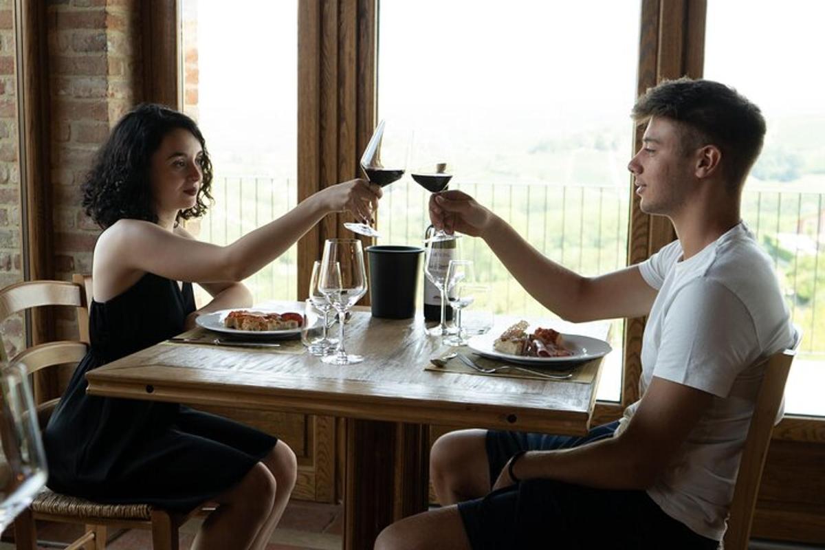 a man and woman sitting at a table with wine glasses