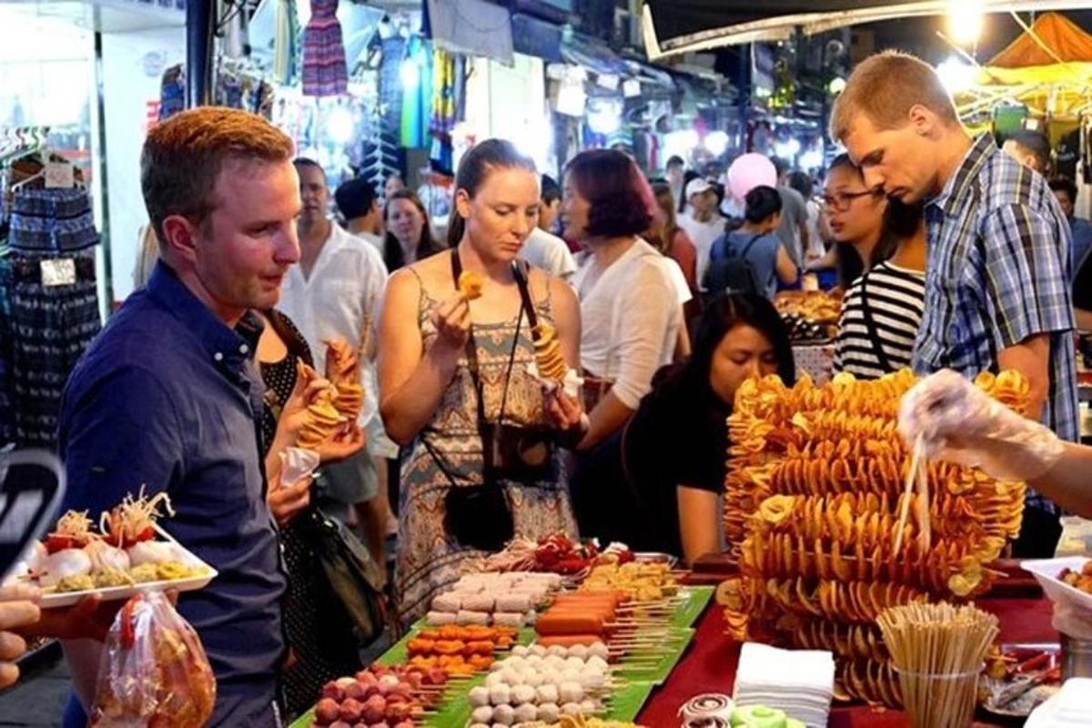 un groupe de personnes debout autour d'un marché avec de la nourriture