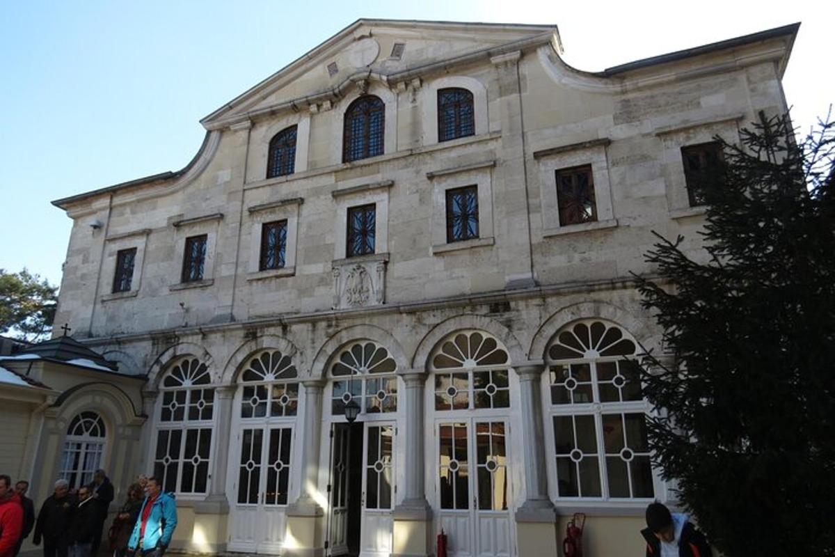 a large building with people standing outside of it