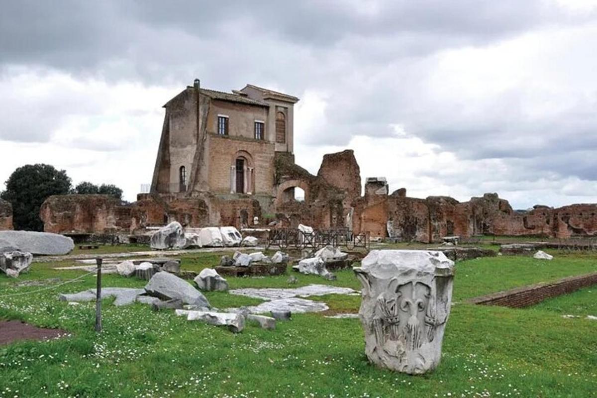an old building with a statue in a field