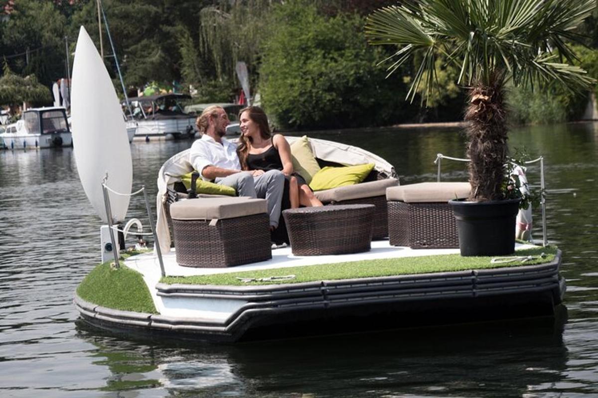 a man and woman sitting on a boat in the water
