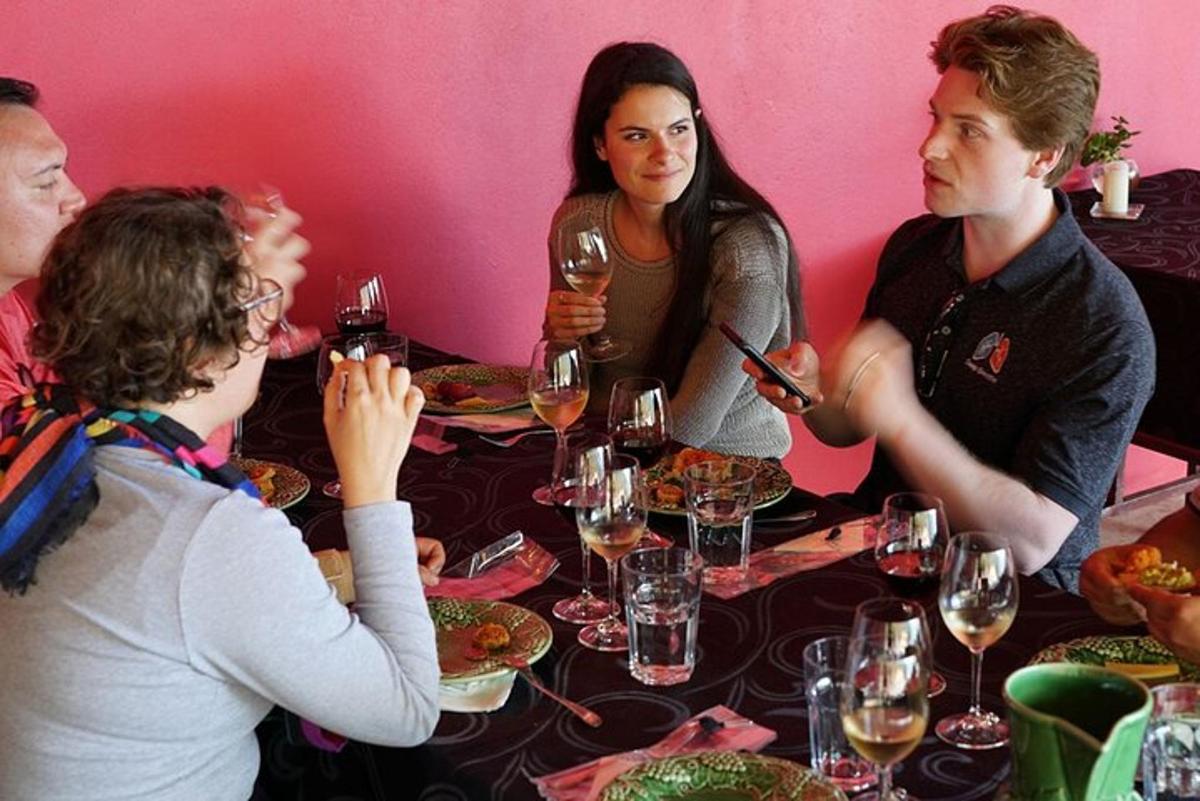 a group of people sitting around a table with wine glasses