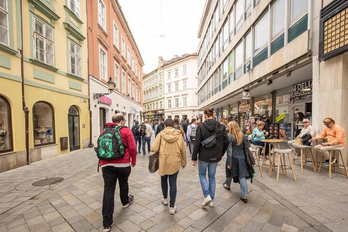 a group of people walking down a city street