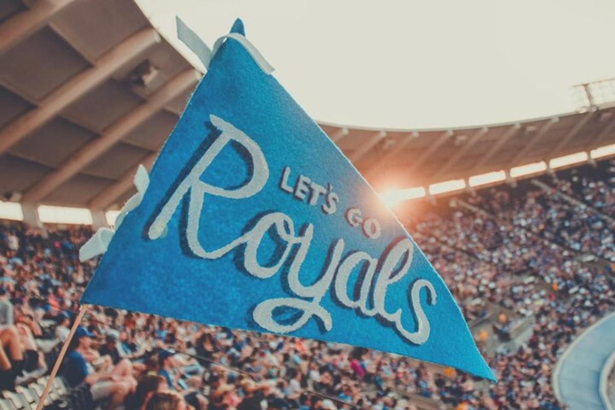 a crowd of people in a stadium with a blue sign