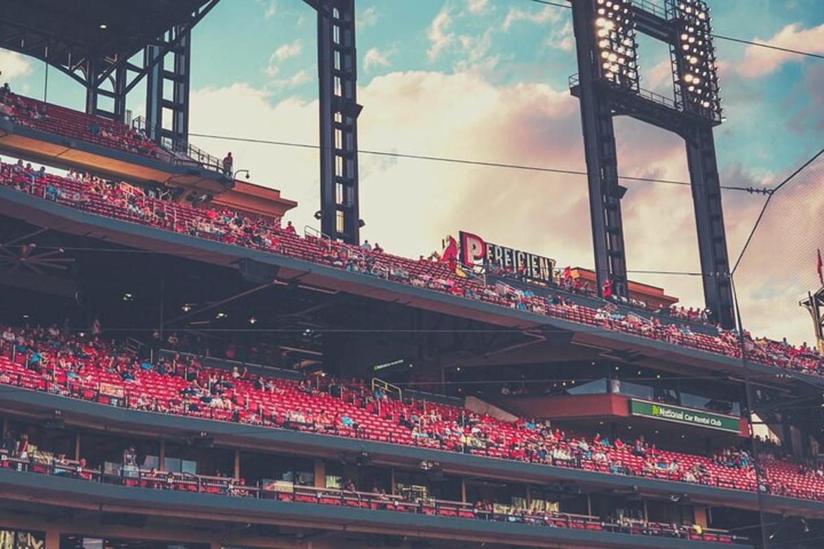 a stadium with red seats at a baseball game