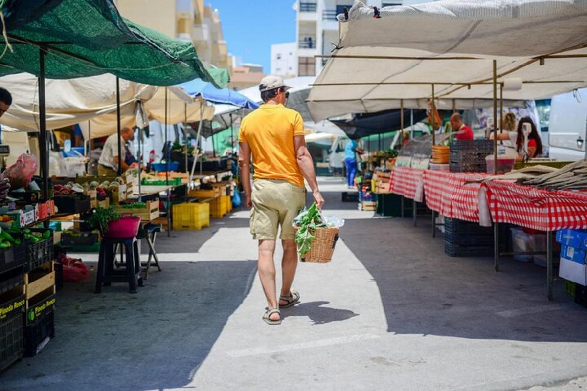 a man walking through an outdoor market