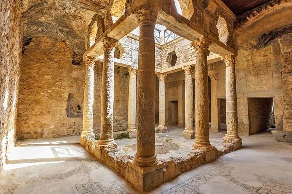 a large room with columns in an old building